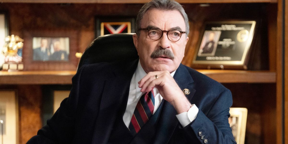 Man in glasses and a suit sitting in his office.