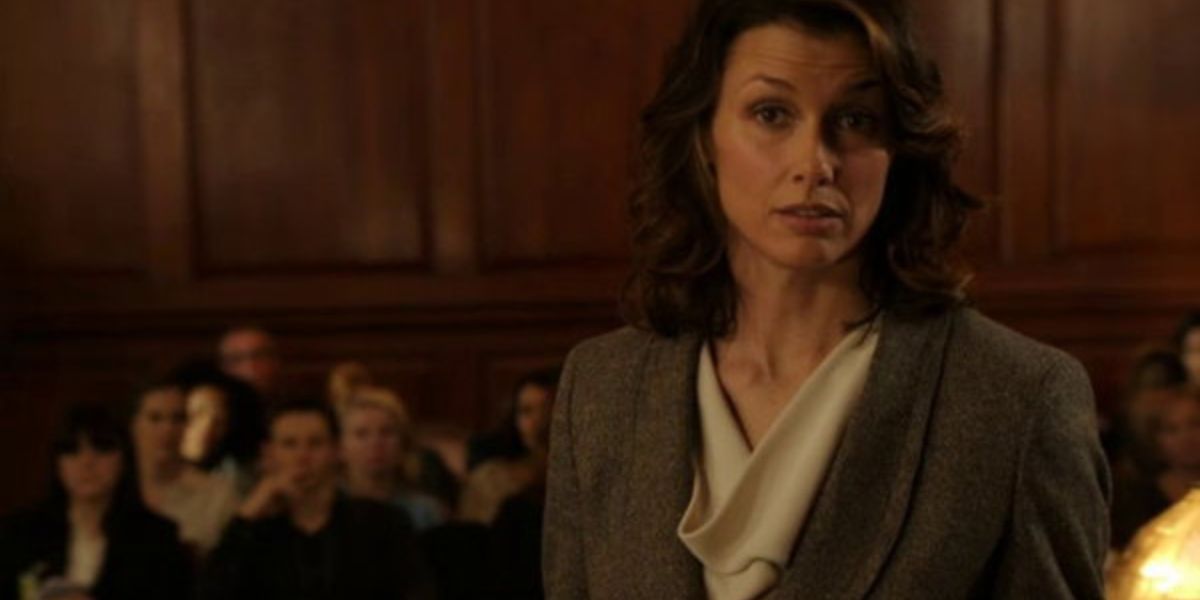 A woman in a suit in a courtroom.