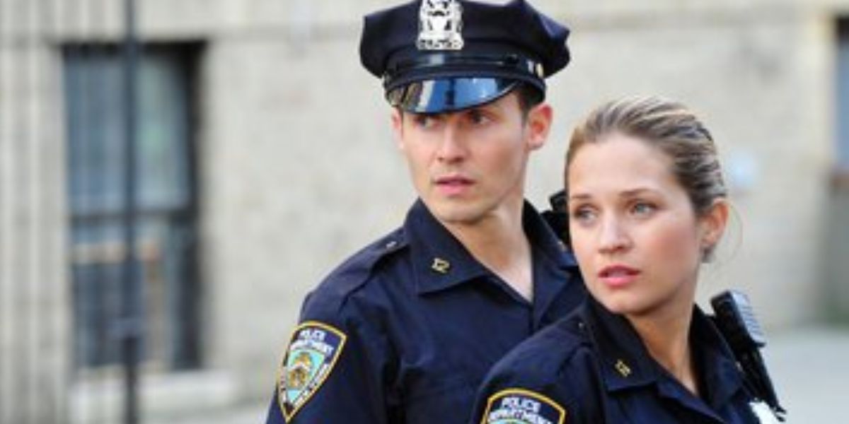 A man and a woman in their police uniforms.