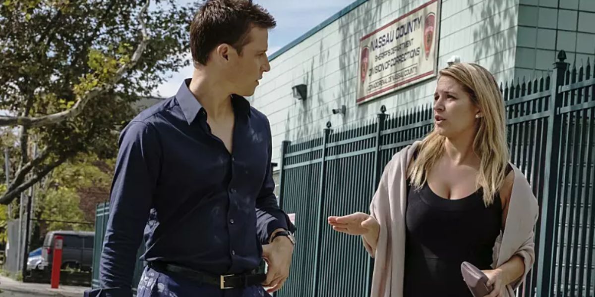 A man and a woman talking to each other on the street.