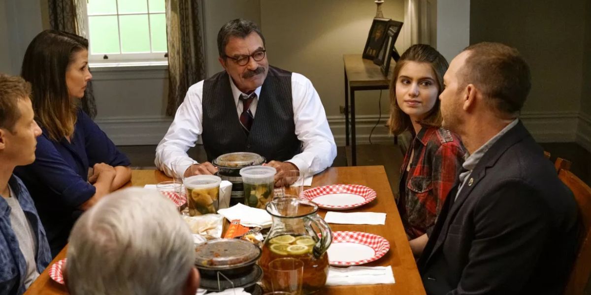 Family sitting around the table with takeout.