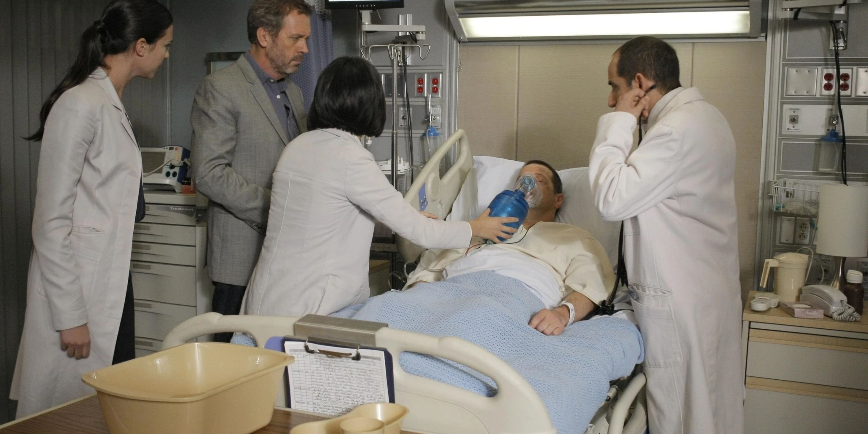 House and a group of interns around a patient's hospital bed in House MD