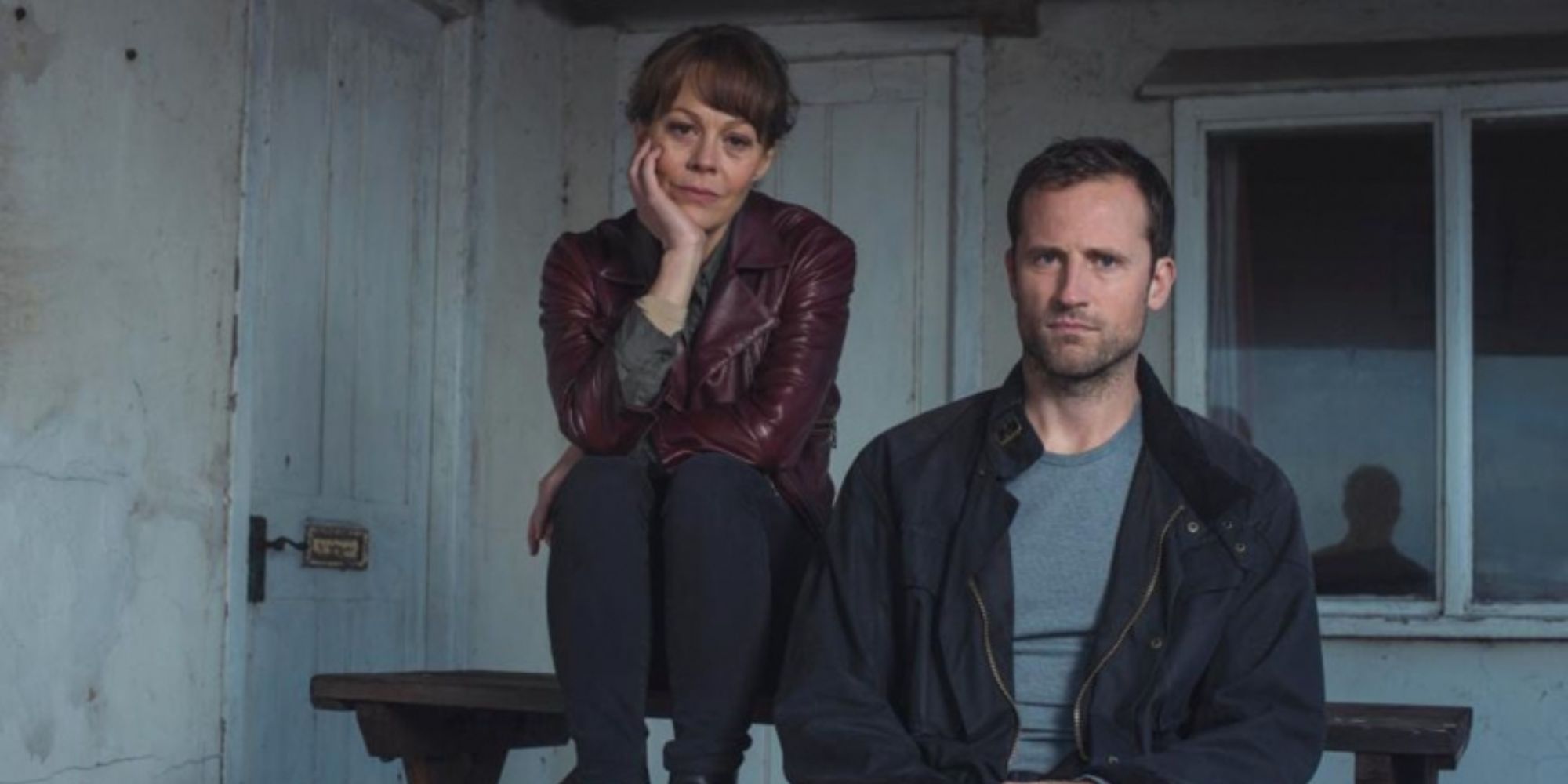 Helen McCrory and Jonathan Forbes sit in a dilapidated house as their characters in Fearless.