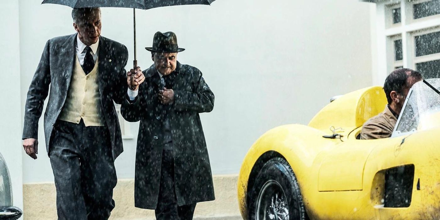 Adam Driver walking in the rain as Enzo Ferrari in Michael Mann's Ferrari