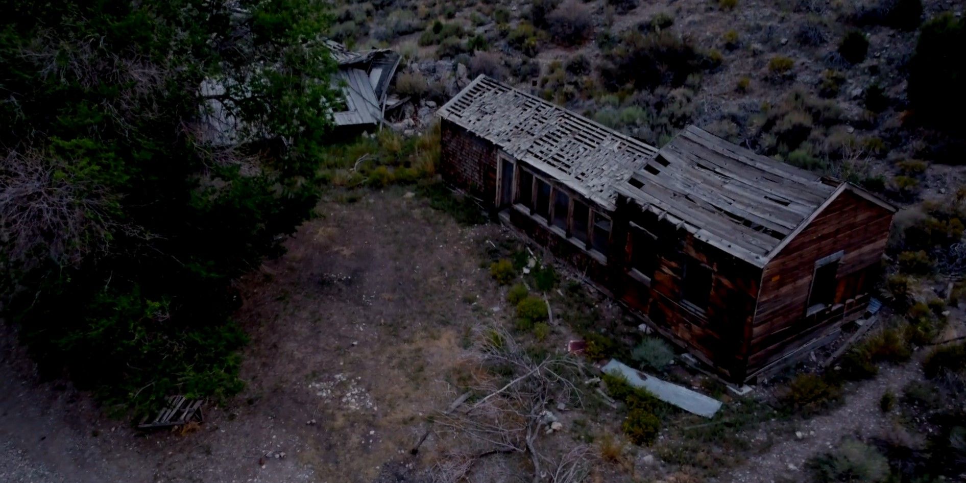 Image from 'Horror in the High Desert 2: Minerva' of a dilapidated shack from an aerial view.