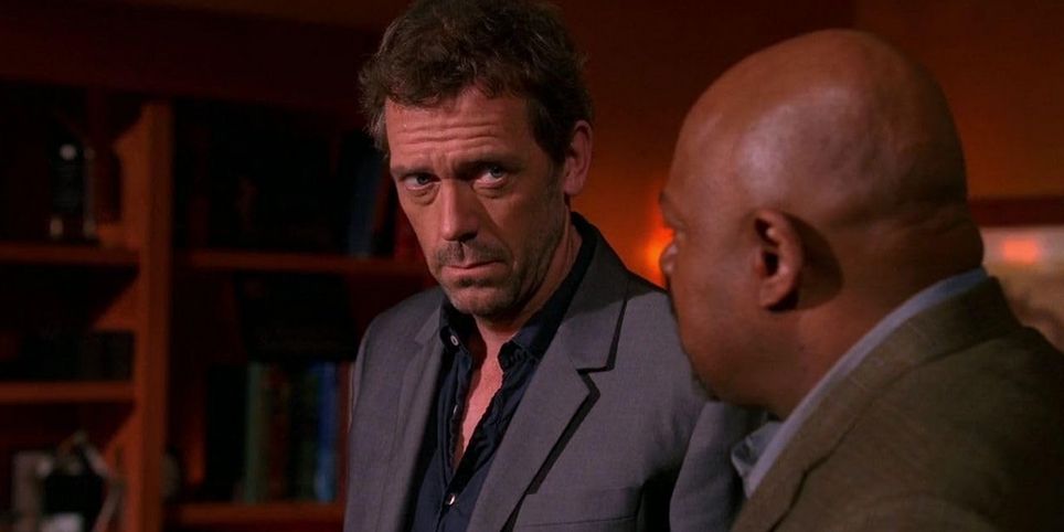 Hugh Laurie as Dr. Gregory House in 'House M.D.' , he is having a serious conversation with another man.