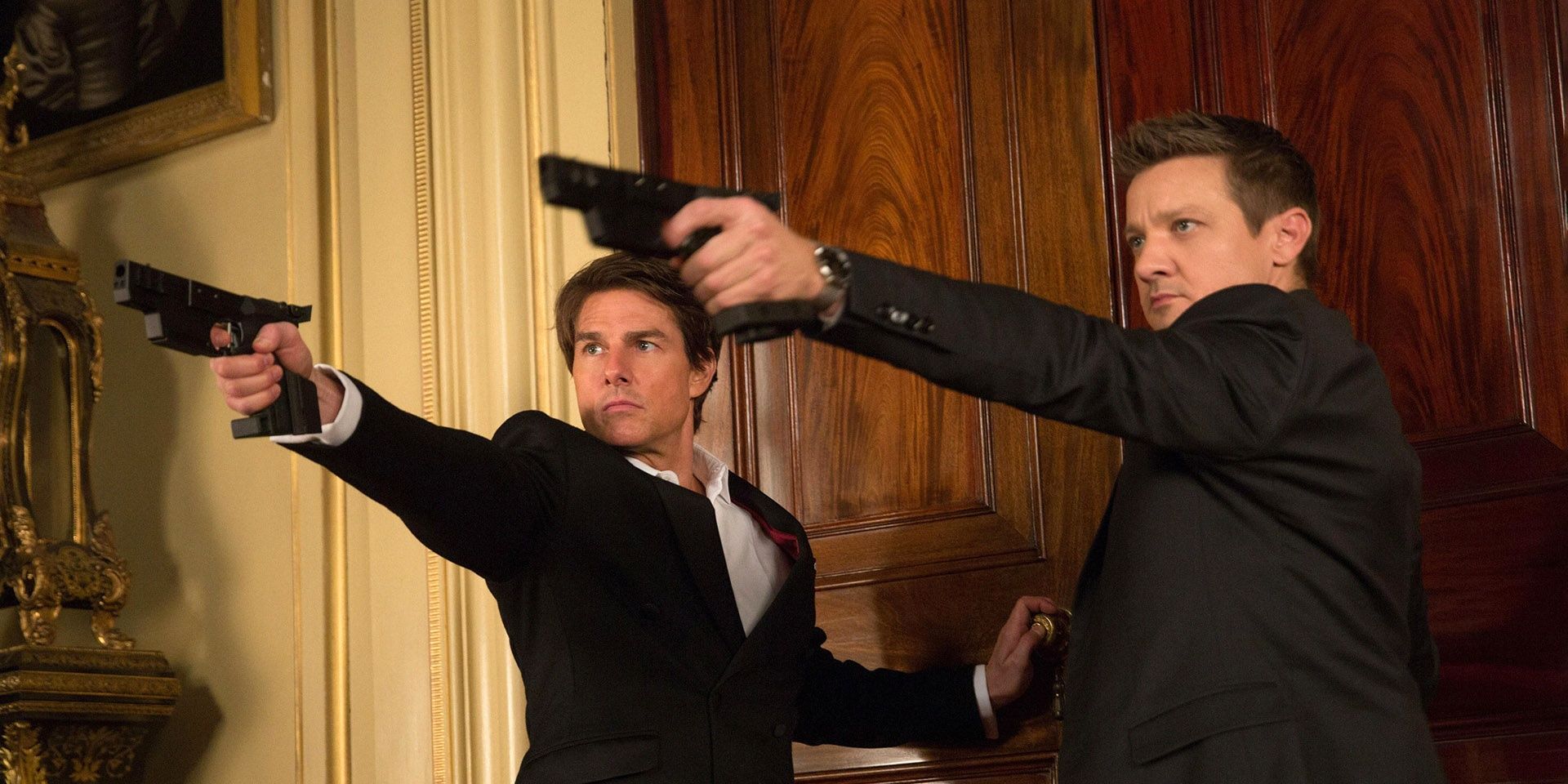 Jeremy Renner and Tom Cruise wielding guns