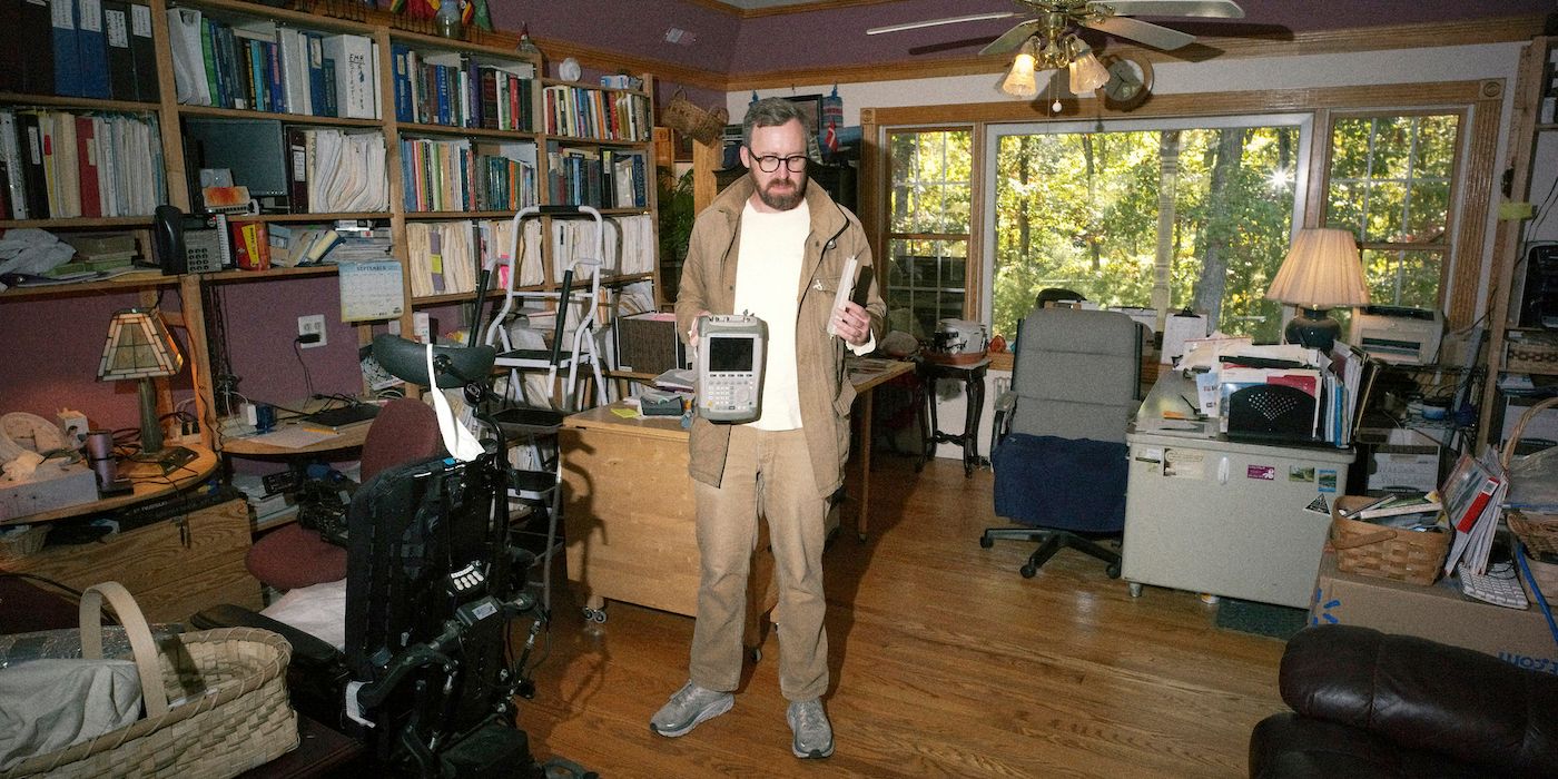 John Wilson standing in the middle of a living room in How to With John Wilson Season 3