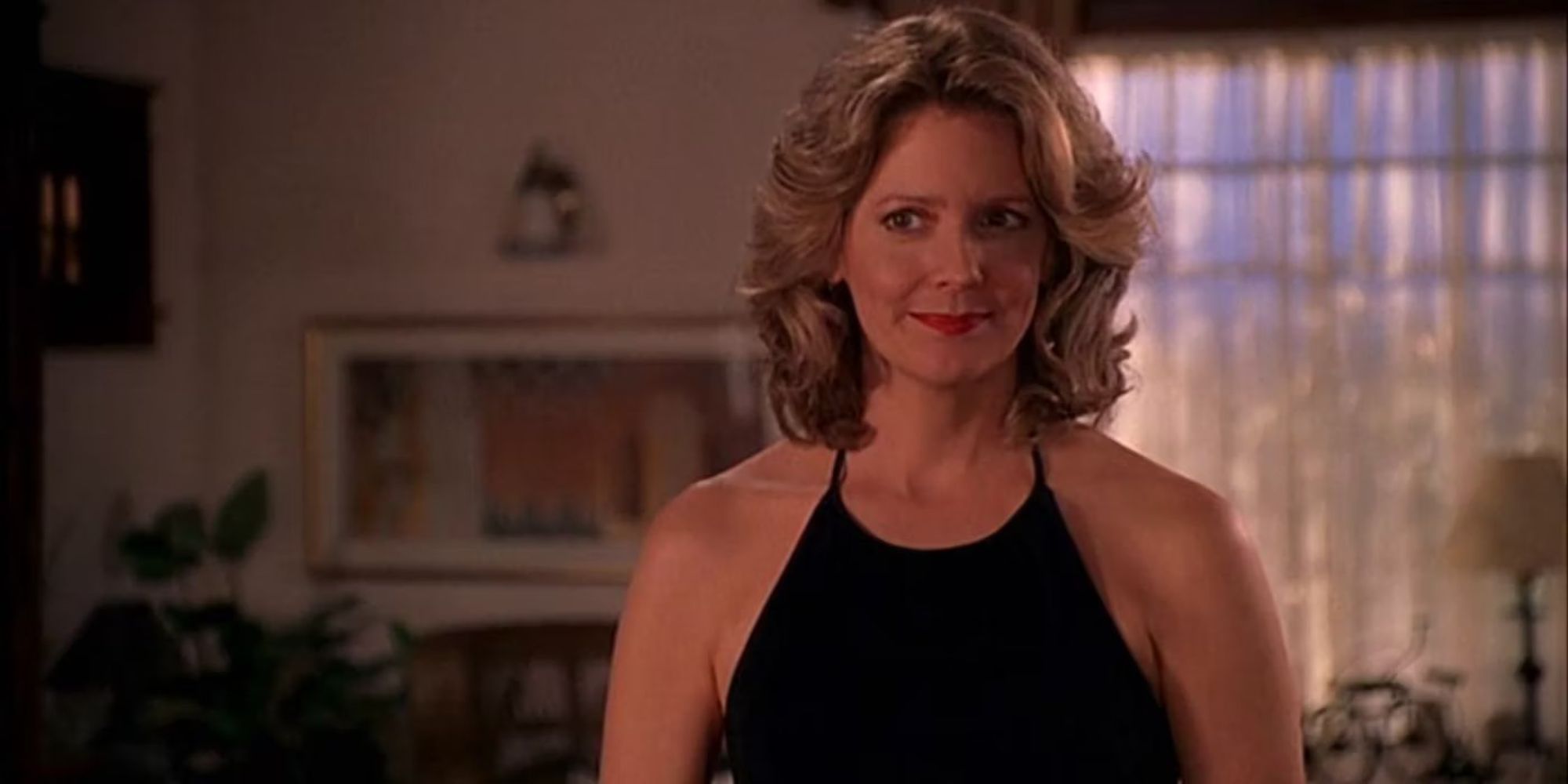 Kristine Sutherland as Joyce Summers smiling slightly in an evening dress in Buffy the Vampire Slayer.
