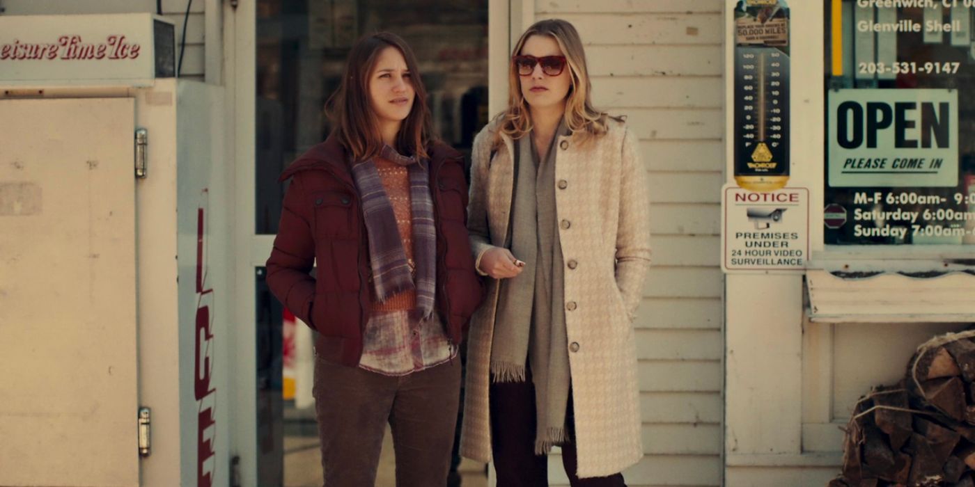 Lola Kirke as Tracy and Greta Gerwig as Brooke stand outside a gas station in Mistress America