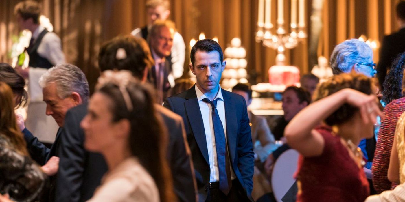 Kendall Roy (Jeremy Strong) standing in a crowd of people dancing in the season 1 finale of Succession.