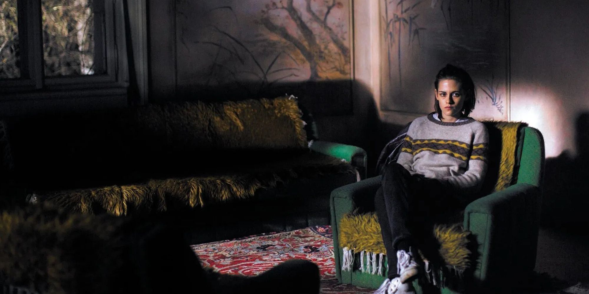 Kristen Stewart as Maureen sitting alone in a dark room in Personal Shopper
