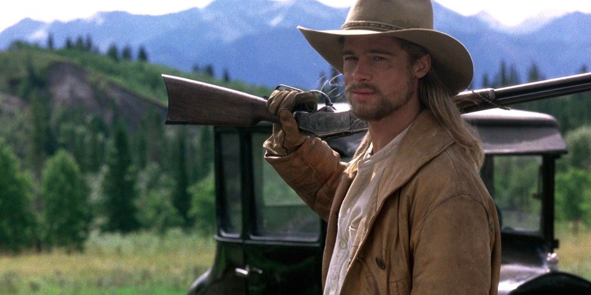 Tristan Ludlow (Brad Pitt) hoists a rifle over his shoulder in Legends of the Fall