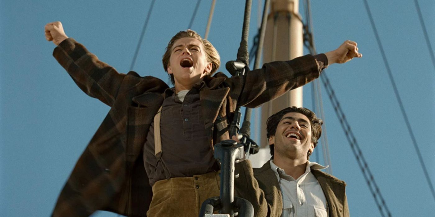 Jack and Fabrizio at the Titanic's bow raising their arms in celebration and laughing