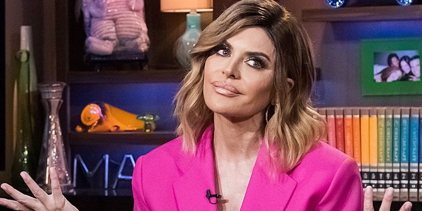 Lisa Rinna on 'Watch What Happens Live' with hands up in pink top
