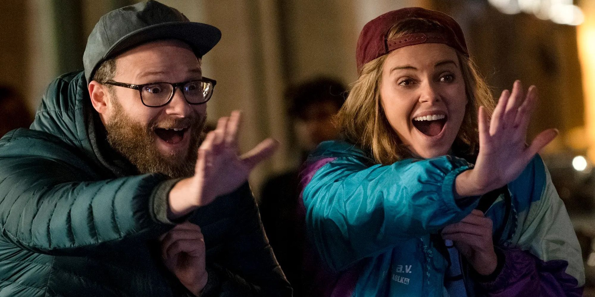 Fred and Charlotte hold their hands up for a high five while smiling in Long Shot (2019).