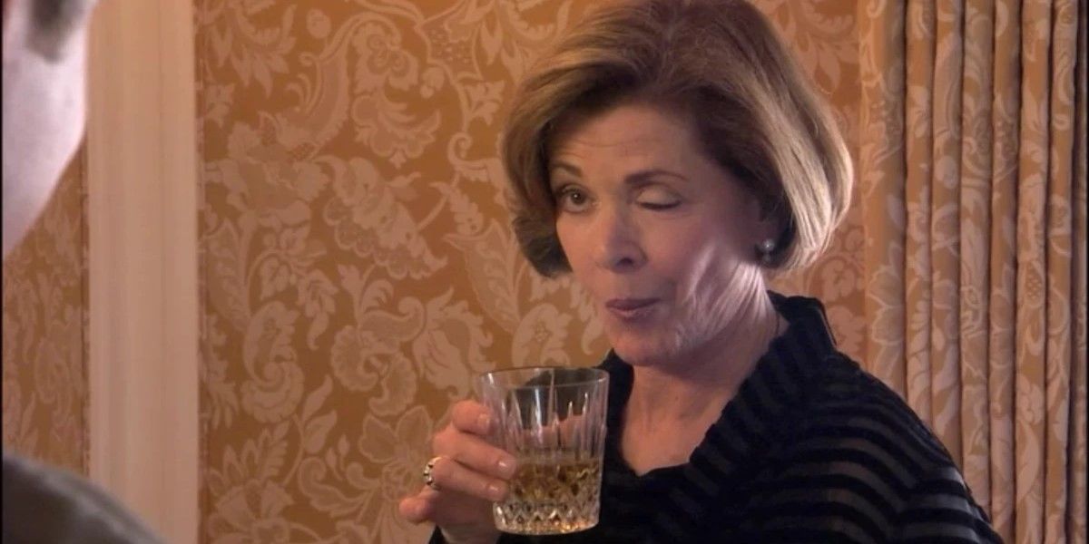 Still from 'Arrested Development': Lucille Bluth (Jessica Walter) holds a glass of alcohol and winks.