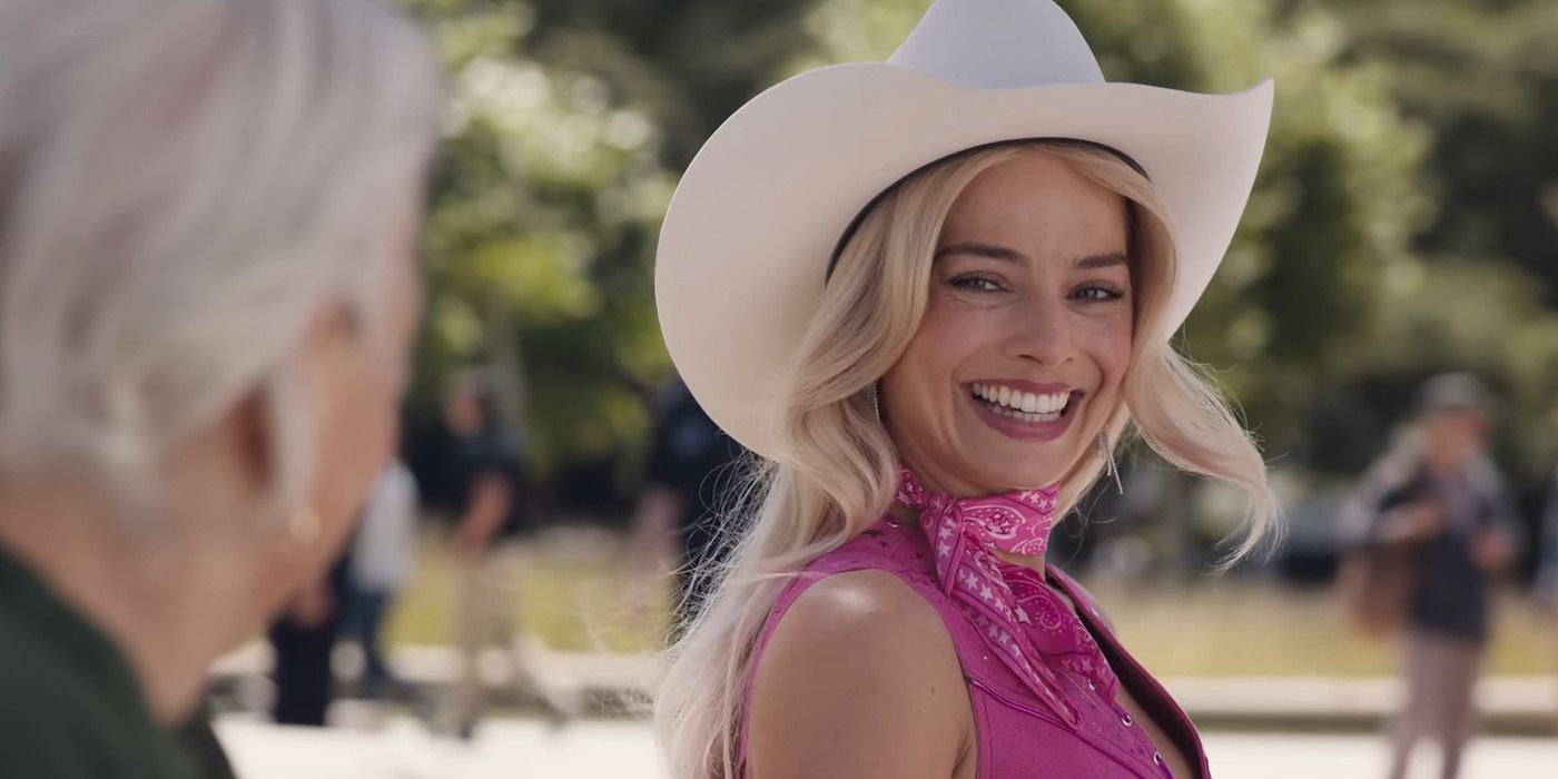 Margot Robbie as Barbie, wearing a cowboy hat and smiling at an older woman at the bus stop in Barbie