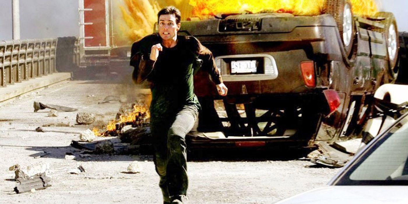 Tom Cruise as Ethan Hunt running down the bridge in front of a burning car in Mission: Impossible III