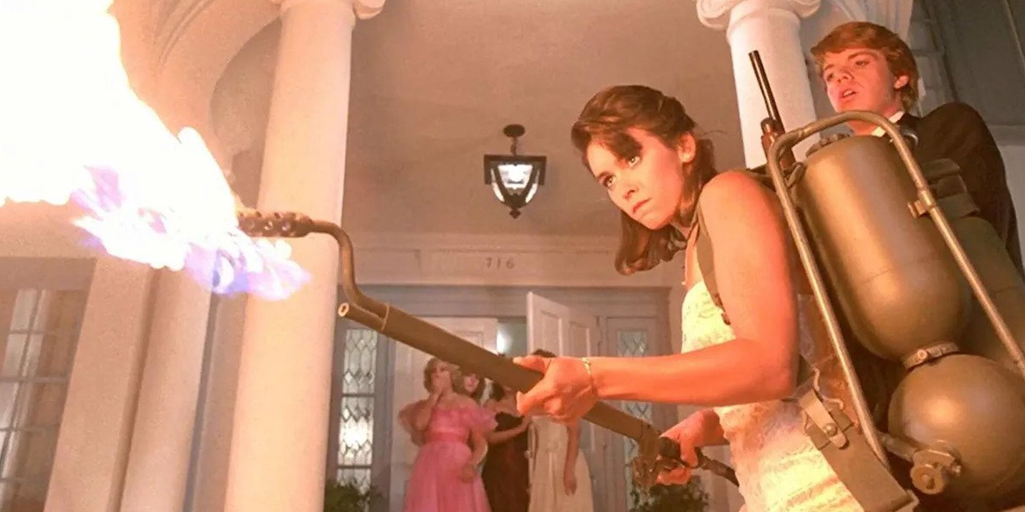 A woman firing a flamethrower at something off-camera in 'Night of the Creeps.' (1986)