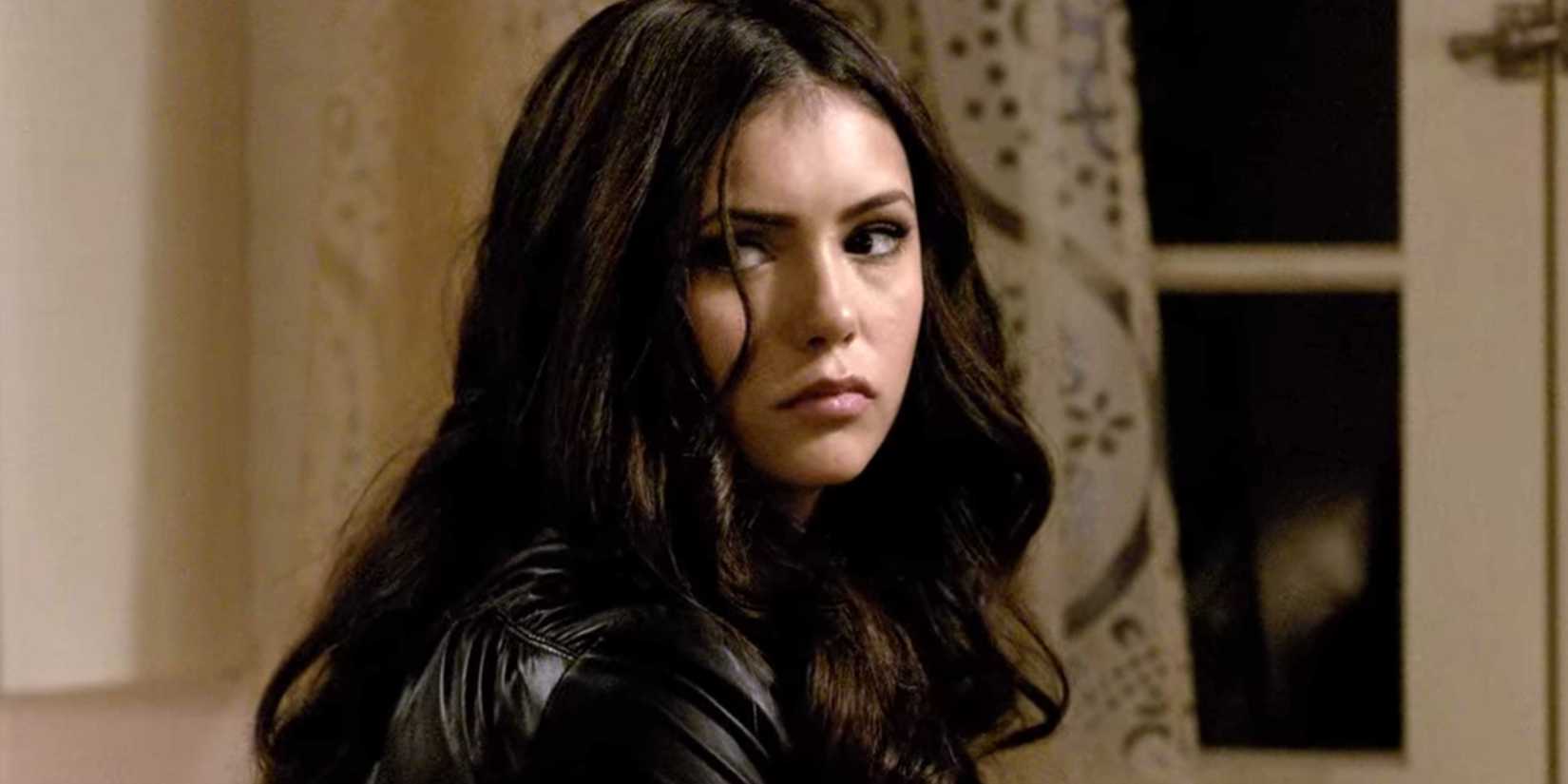 Nina Dobrev as Katherine Pierce inside a house looking behind her in The Vampire Diaries.