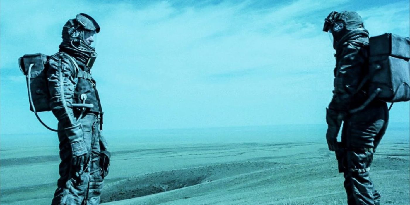 Two astronauts standing on the shore facing one another in On the Silver Globe