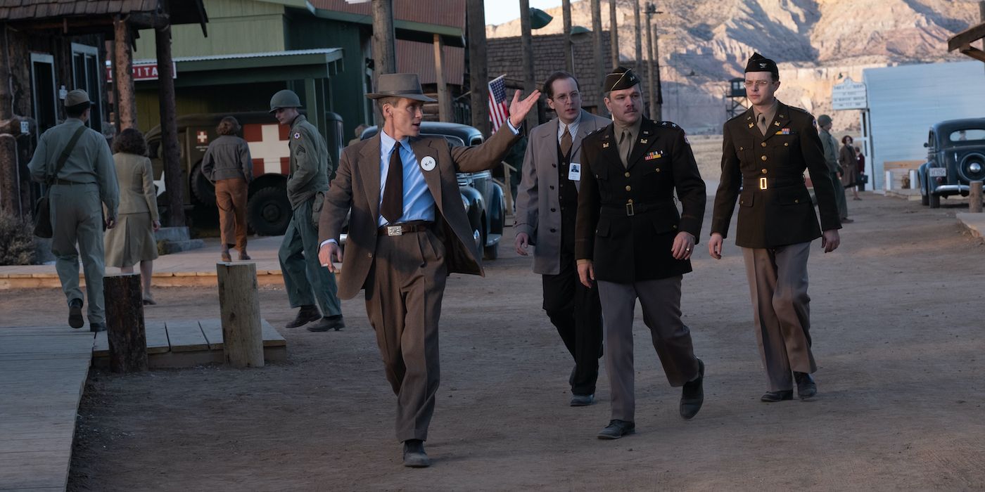Cillian Murphy, Matt Damon, Dane DeHaan as Robert Oppenheimer, Leslie Groves, and Kenneth Nichols walking around Los Alamos in Oppenheimer.
