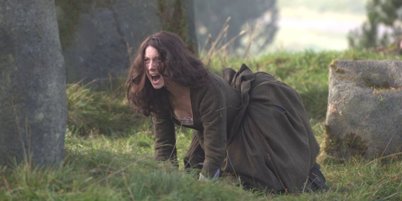 Caitríona Balfe as Claire on her hands and knees yelling, at the location Craigh na Dun in Outlander.
