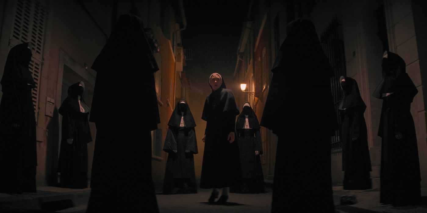 Taissa Farmiga surrounded by nuns in The Nun II