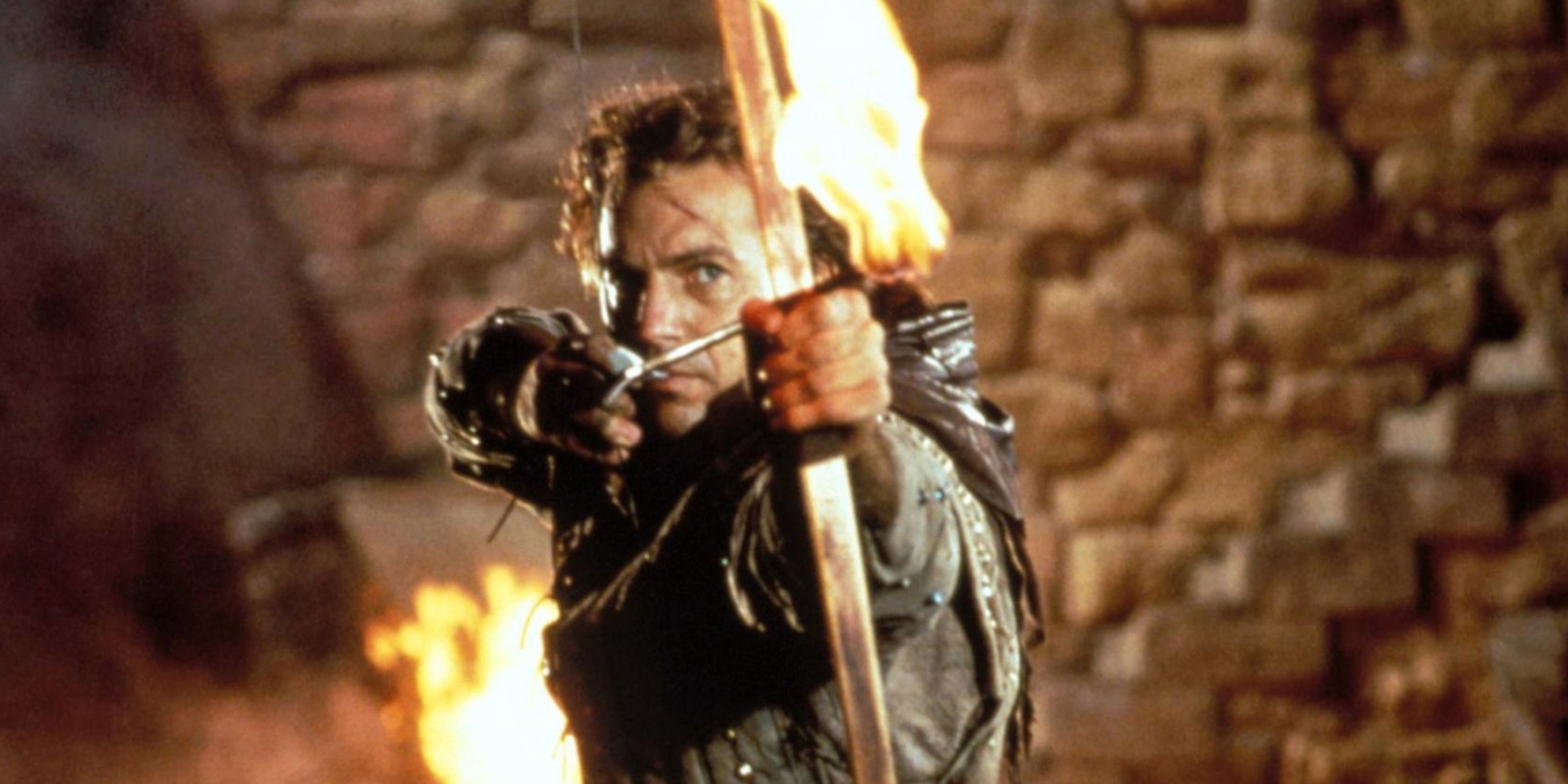 Robin Hood ,played by actor Kevin Costner, prepares to shoot a flaming arrow in Robin Hood: Prince of Thieves