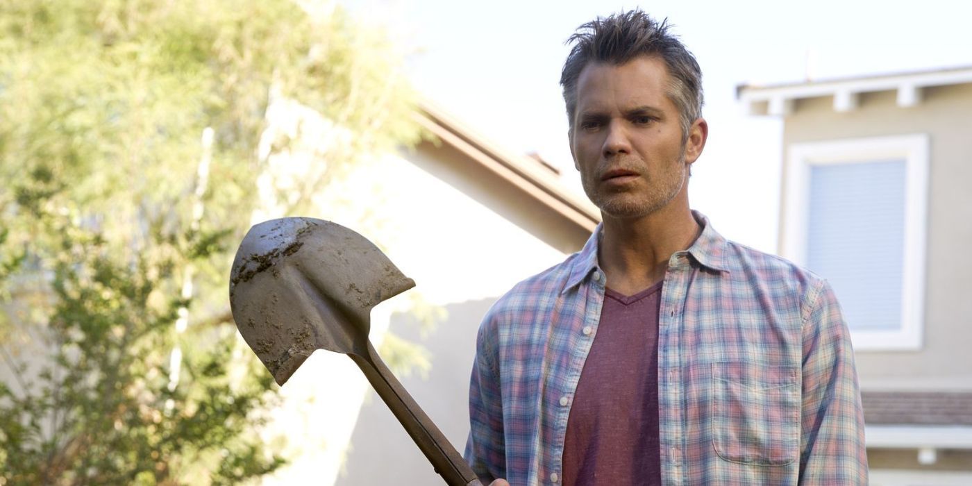 Joel (Timothy Olyphant) standing outside his house holding a shovel in Netflix's Santa Clarita Diet