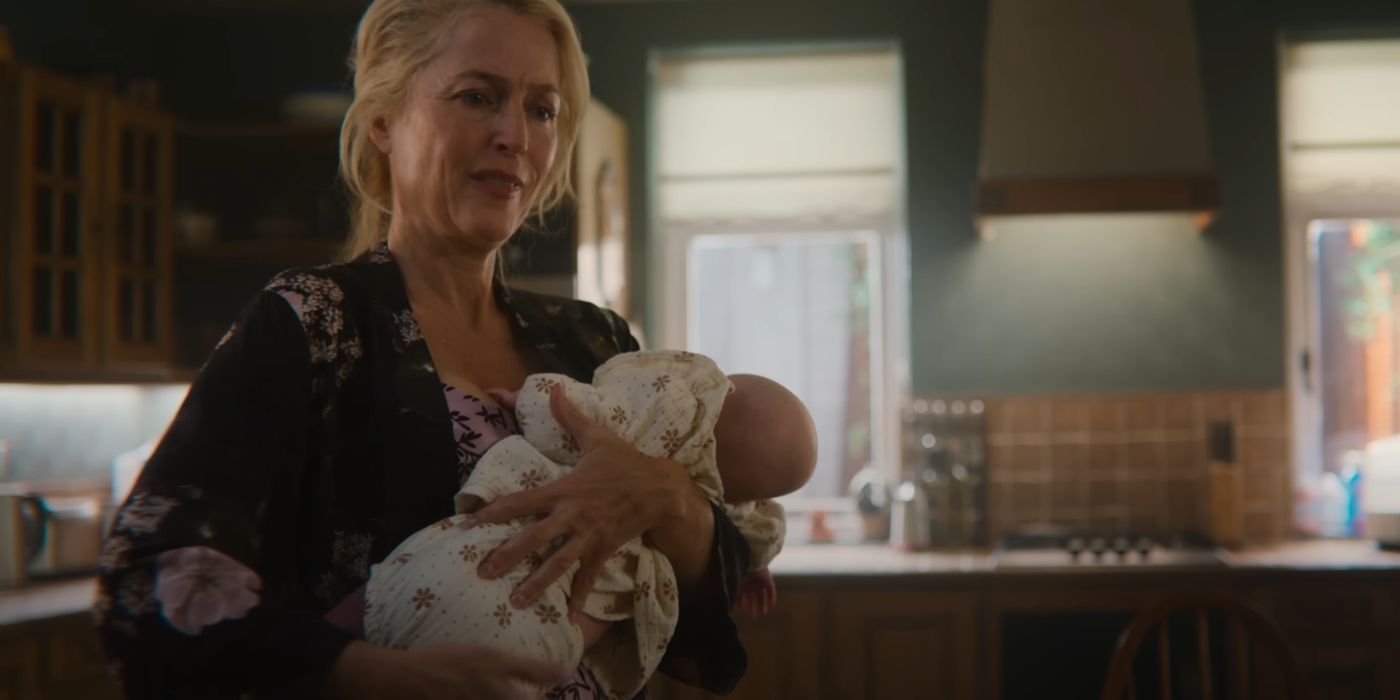 Gillian Anderson holding a baby as Jean Milburn in Sex Education Season 4