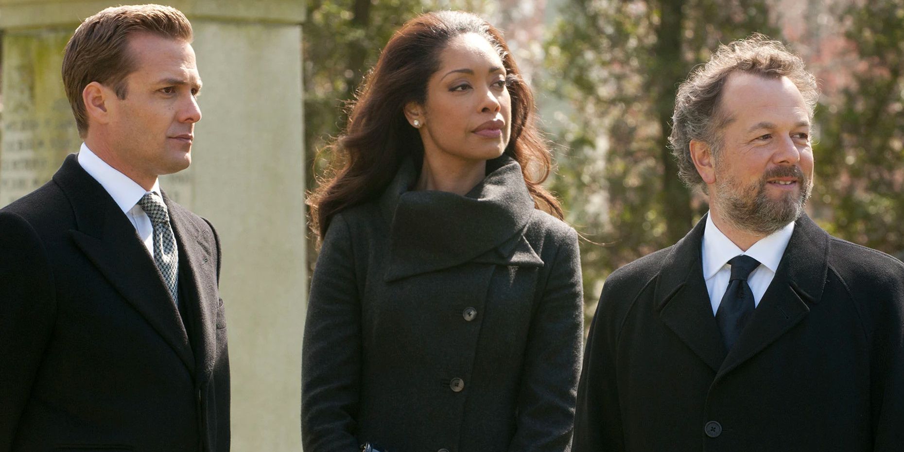 Gabriel Macht, Gina Torres, and David Constabile standing together in a cemetery in Suits