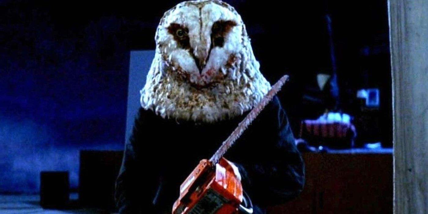 A man with an owl mask holding a chainsaw in Stage Fright