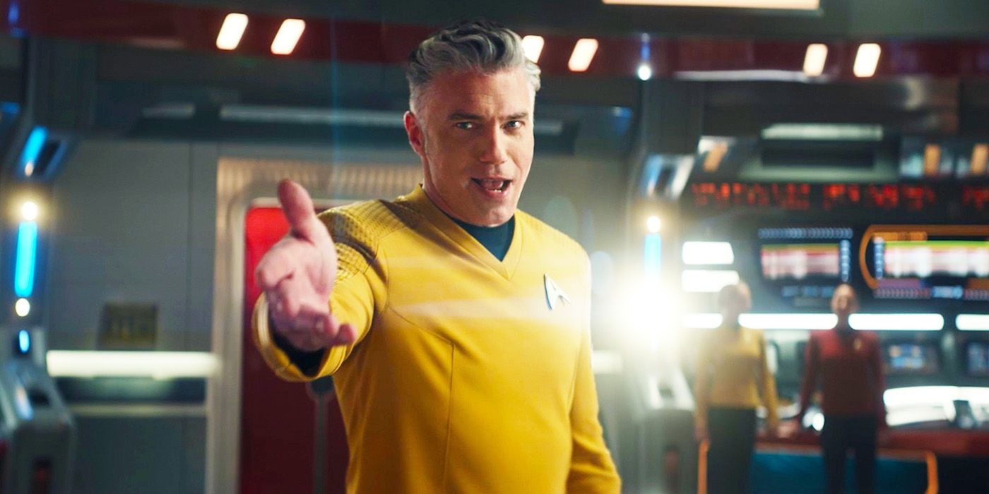 Anson Mount as Captain Pike in Star Trek Strange New Worlds extending his hand toward the camera in the musical episode, he wears a yellow uniform.