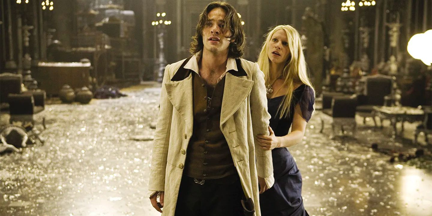 Yvaine (Claire Danes), a fallen star, clutches onto Tristan's (Charlie Cox) arm in a large room with broken glass everywhere.