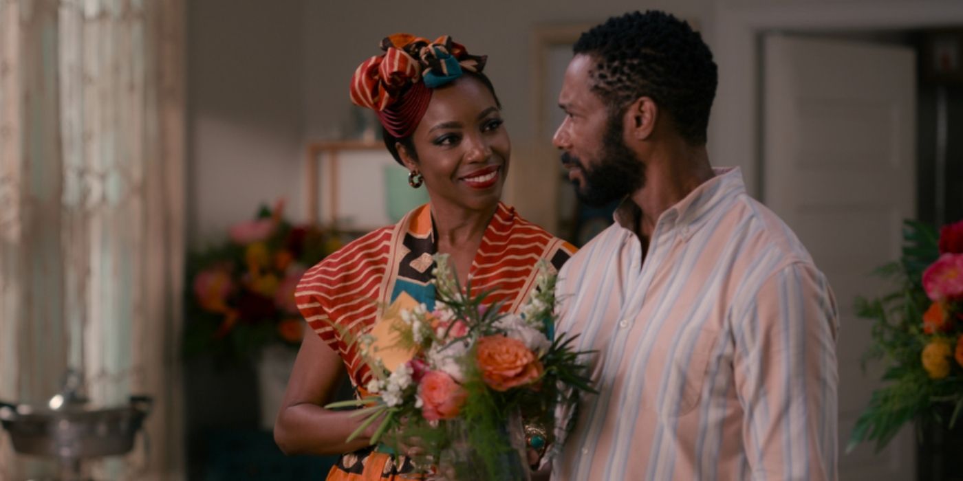 Heather Headley as Helen Decatur holding flowers and walking with Dion Johnstone as Erik Whitley in Sweet Magnolias Season 2 