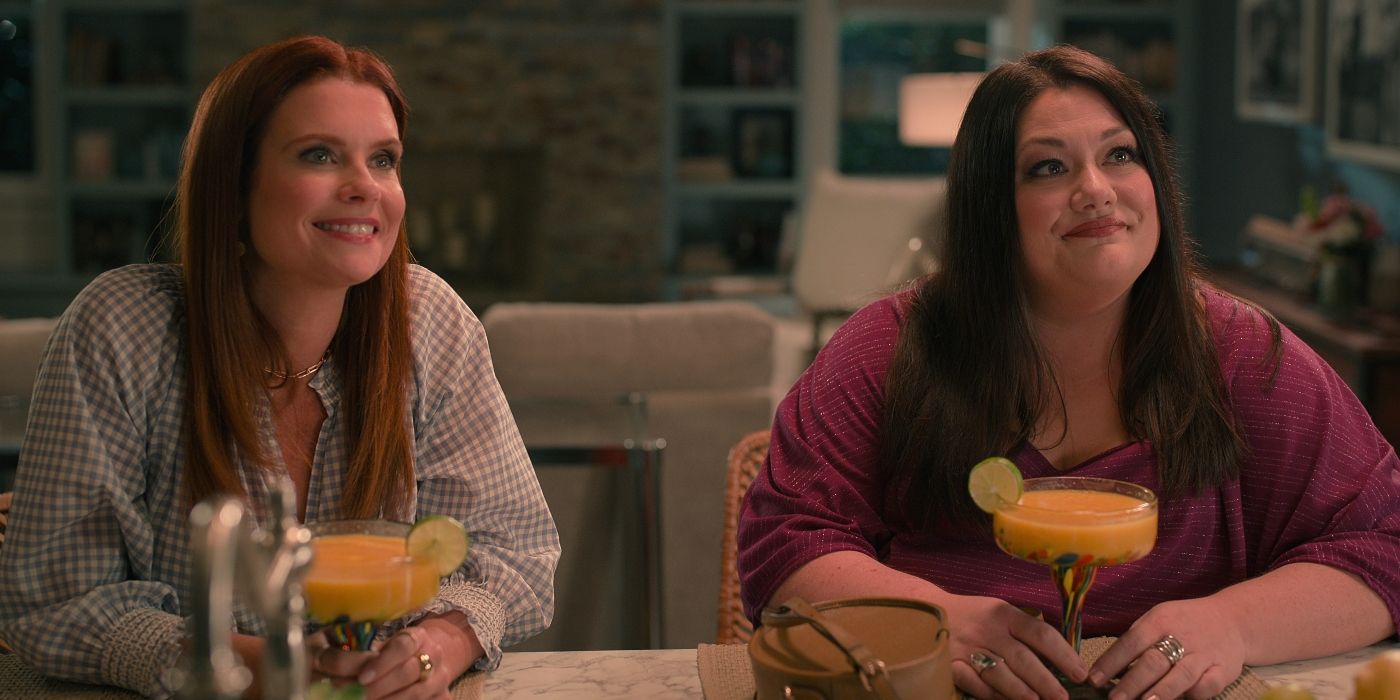 Joanna Garcia Swisher as Maddie Townsend and Brooke Elliott as Dana Sue Sullivan in sitting at a breakfast bar with drinks in Sweet Magnolias Season 3