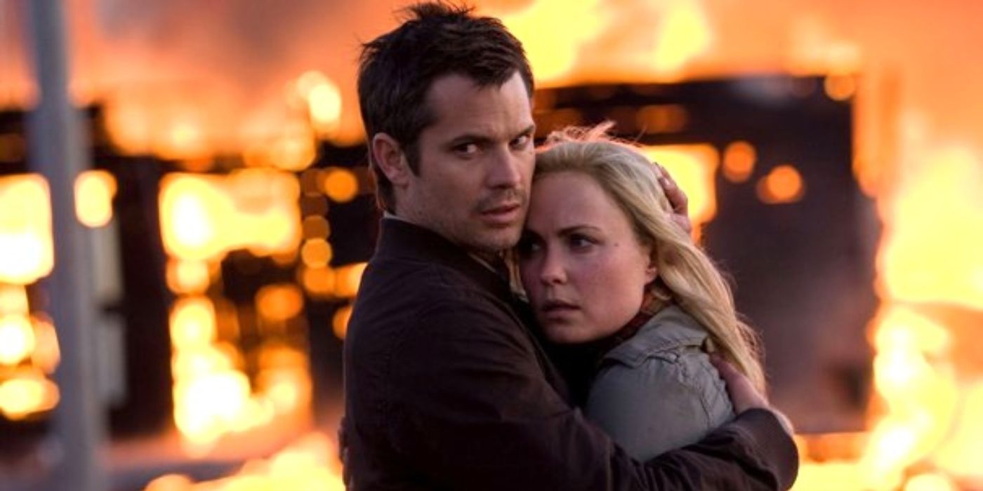 Timothy Olyphant et Radha Mitchell s'embrassent alors qu'un feu flambe derrière eux dans 