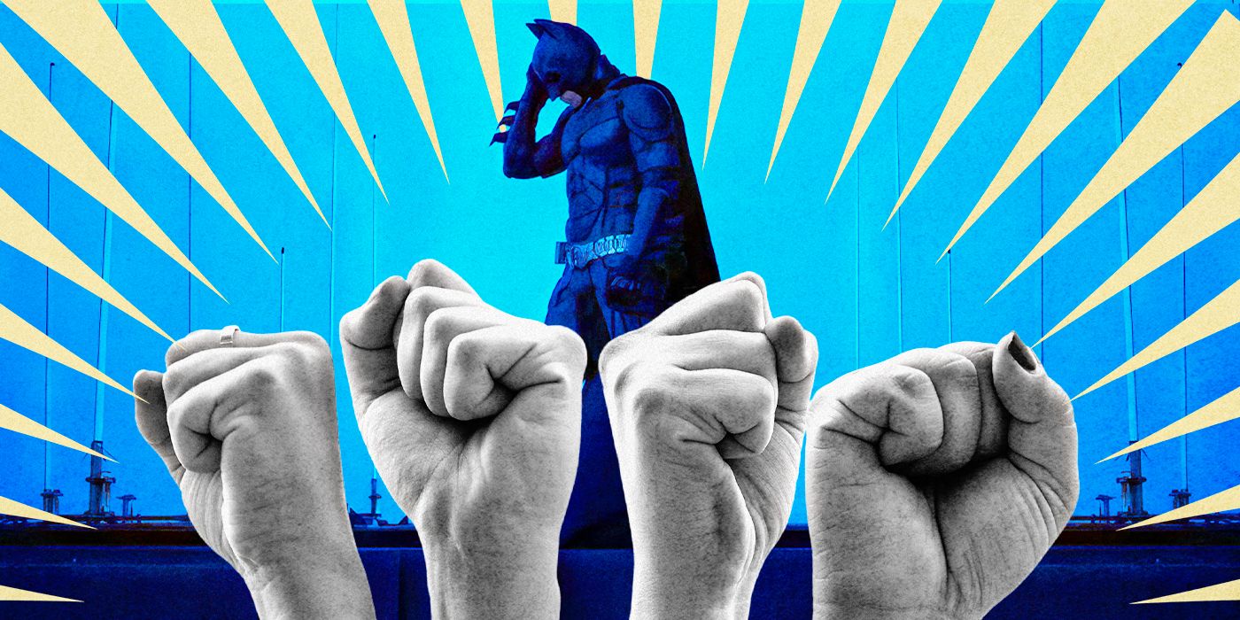 Image of The Dark Knight standing behind four raised fists