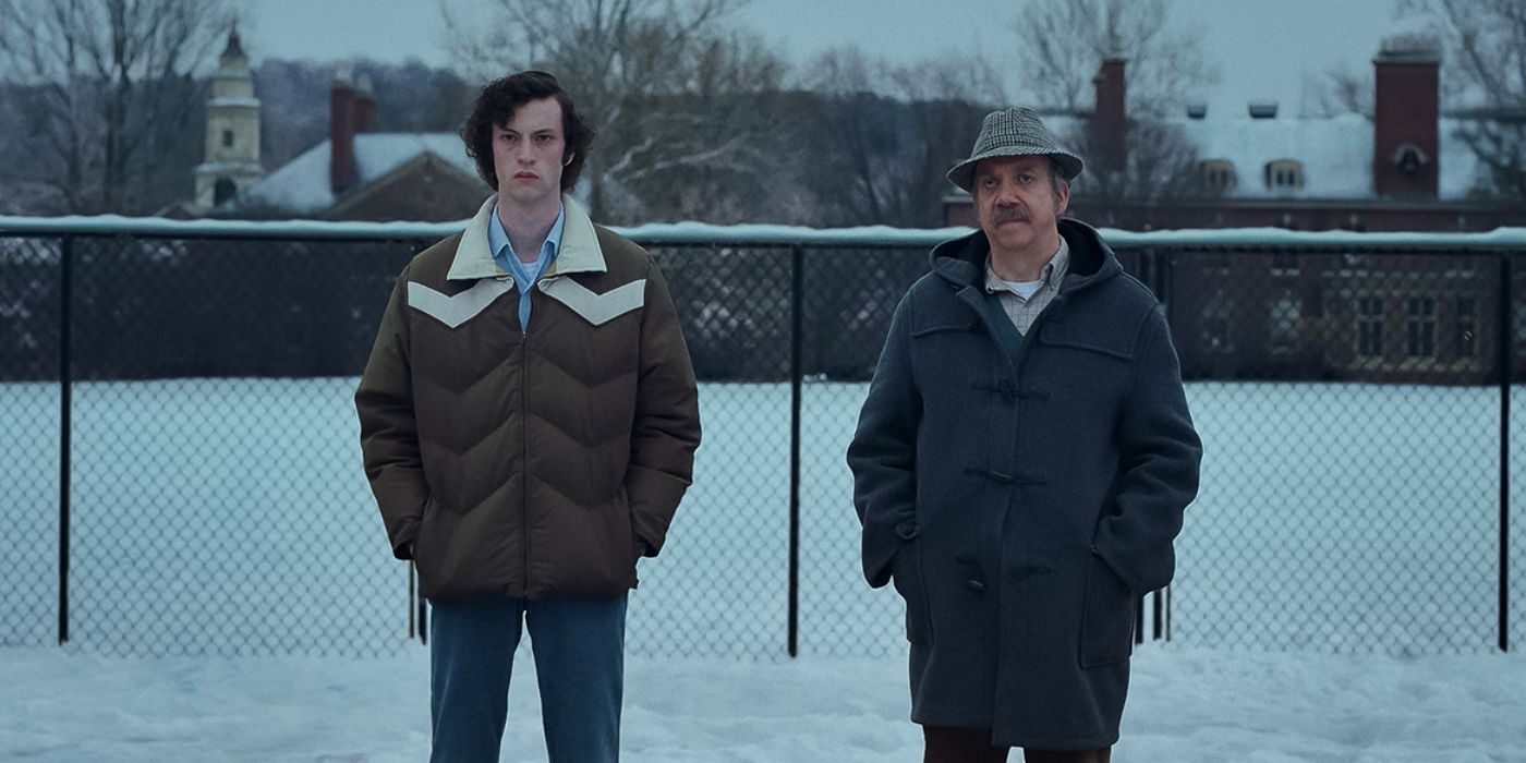 Paul Giamatti and Dominic Sessa as Angus and Paul standing in snow in The Holdovers