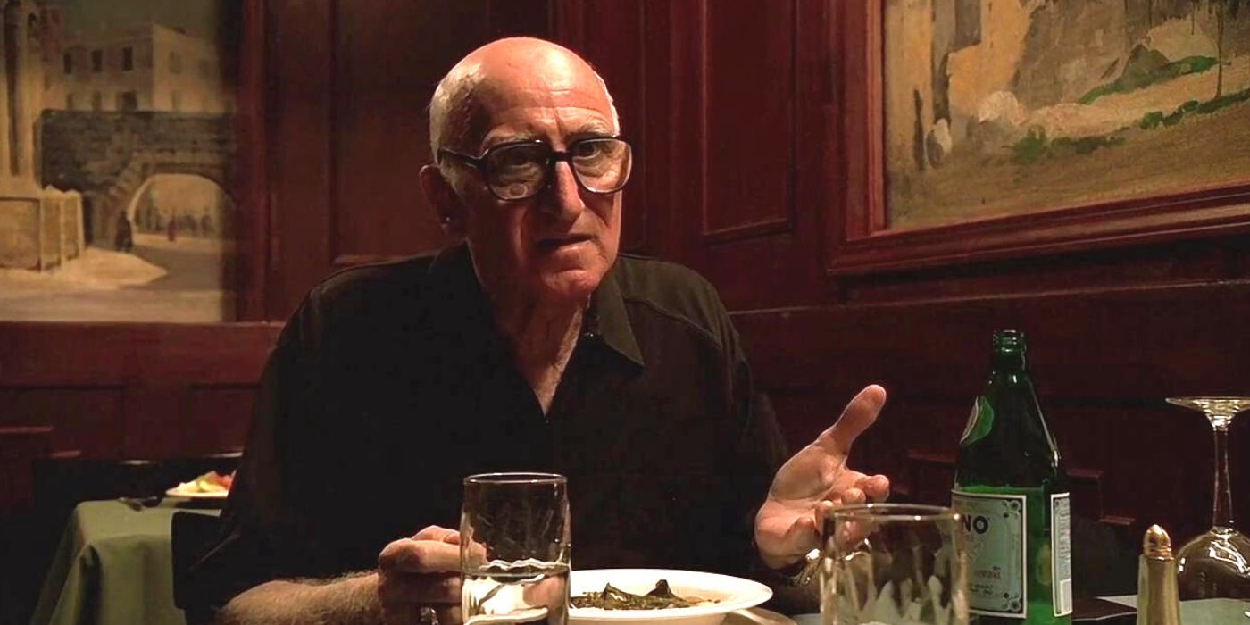 Dominic Chianese sitting at a table in The Sopranos