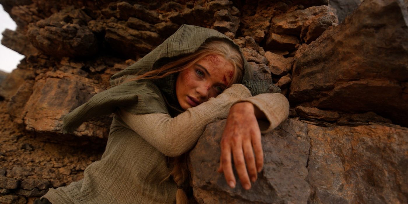 The Witcher Season 3 Episode 7 Freya Allan hanging over a rock, exhausted in the desert