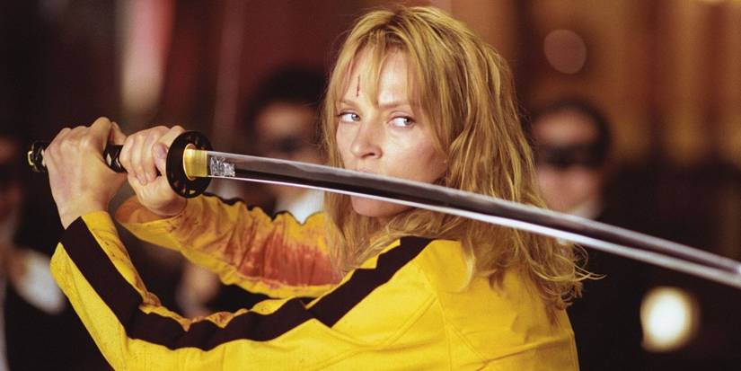 Uma Thurman as The Bride in a yellow and black jumpsuit wielding a katana in Kill Bill vol. I.