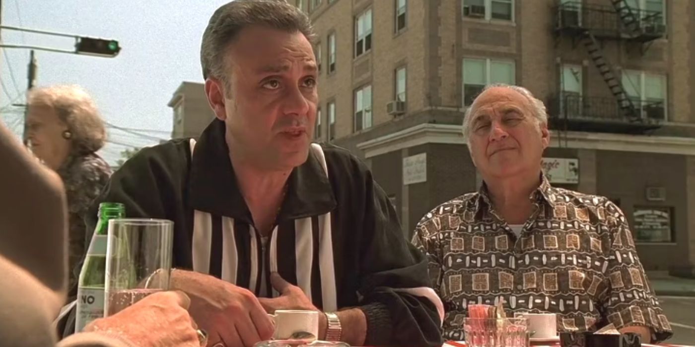 Vincent Curatola and Jerry Adler sitting at a table outside in The Sopranos