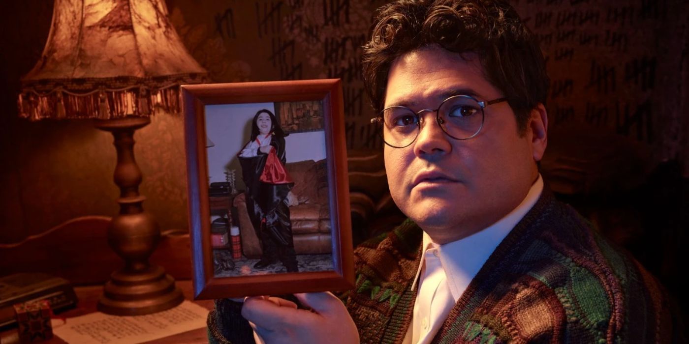 Guillermo de la Cruz, played by Harvey Guillén, holding a picture of himself dressed as Armand as a kid in 'What We Do in the Shadows.'