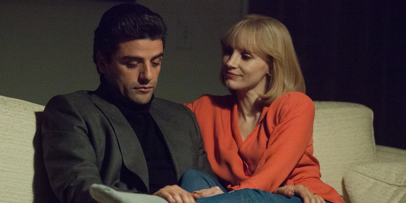 Oscar Isaac and Jessica Chastain as Abel and Anna Morales sitting on a couch talking in A Most Violent Year.