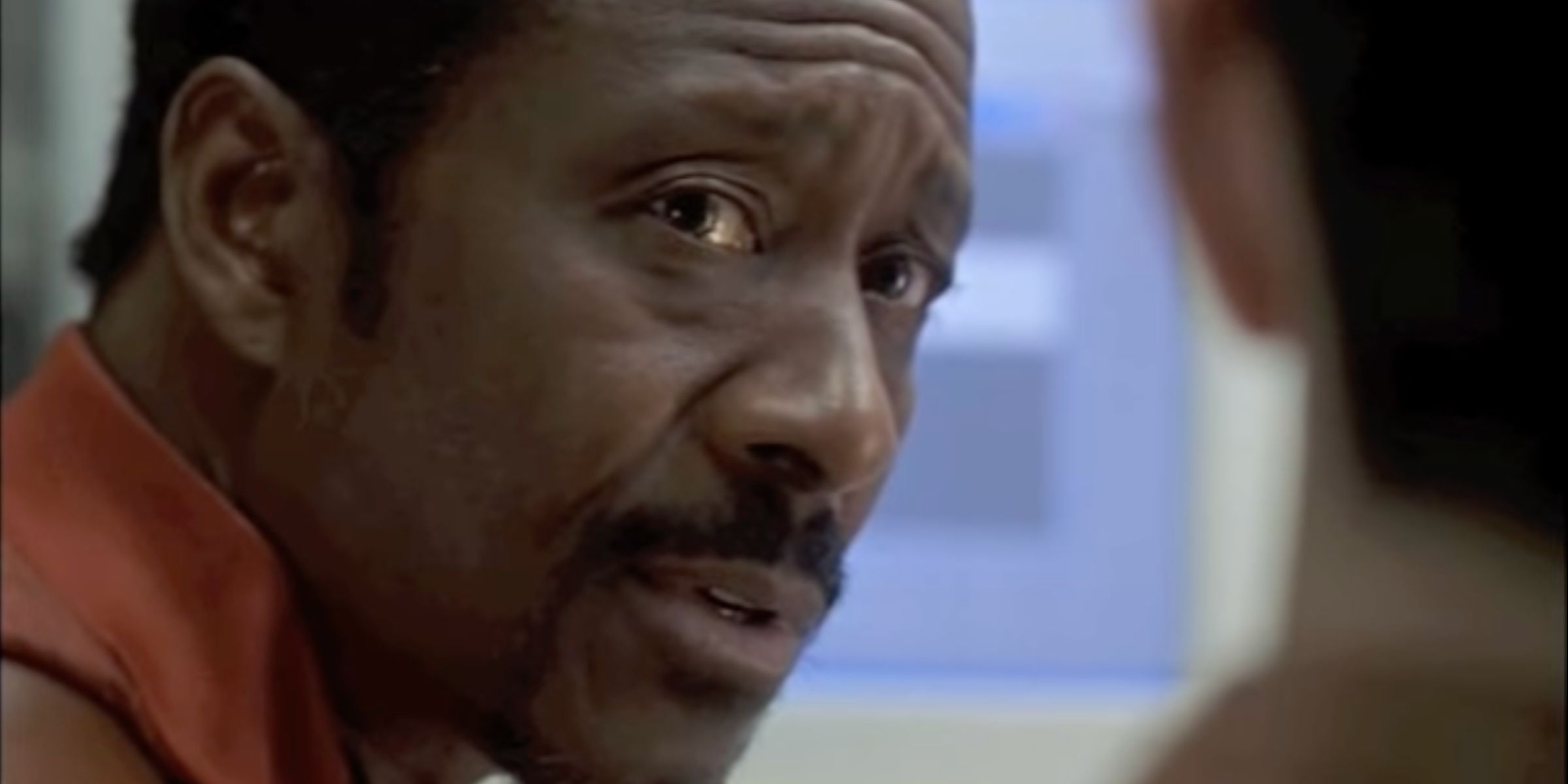 Detective Lester Freamon mentors a colleague as they classify recorded phone calls.
