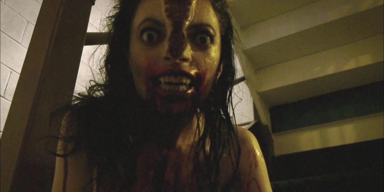 Still from V/H/S: A woman transforms into a monster with her head splitting in two.