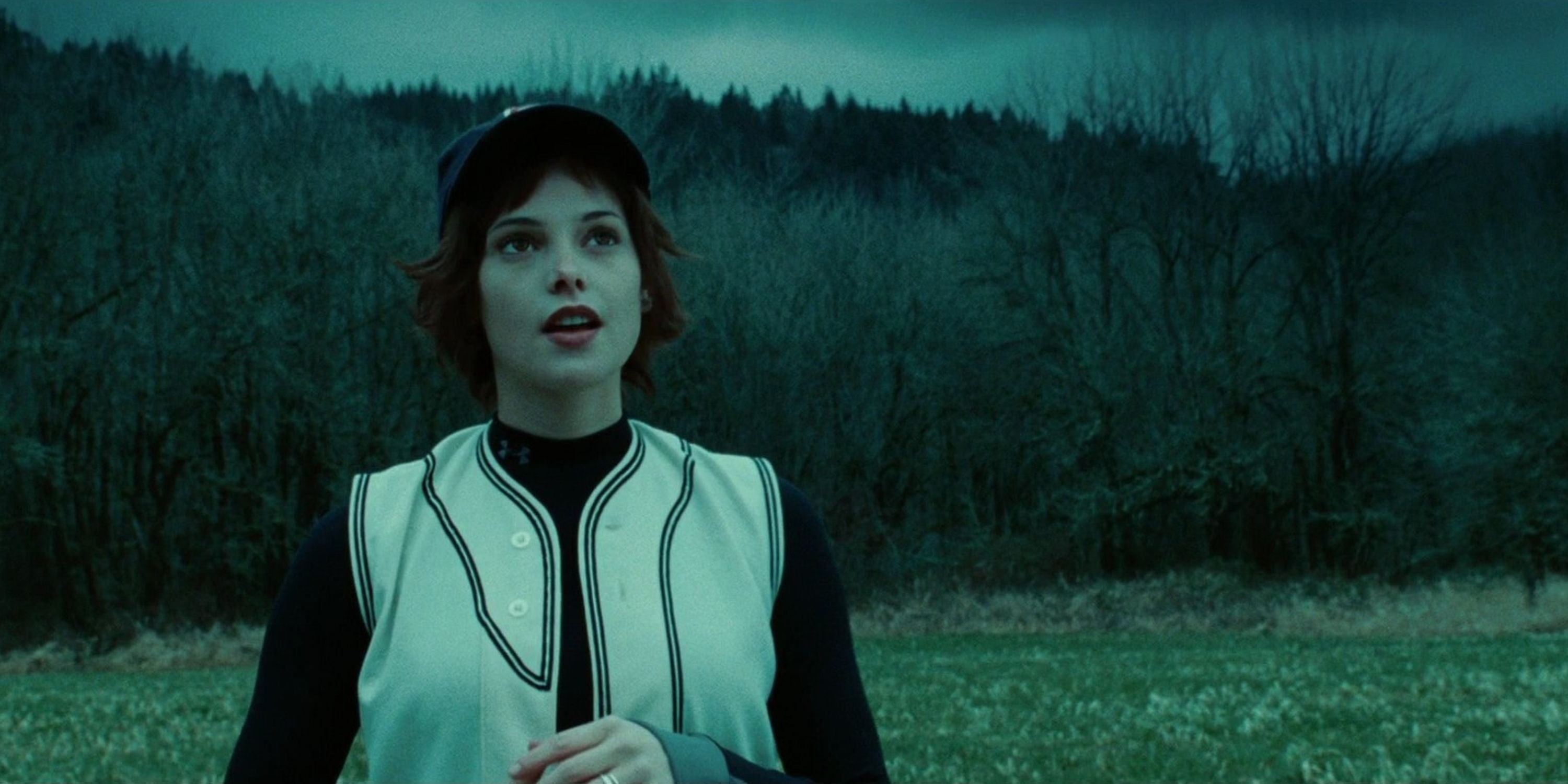 Alice Cullen in 'Twilight', she is a pale white woman in baseball getup in a field.